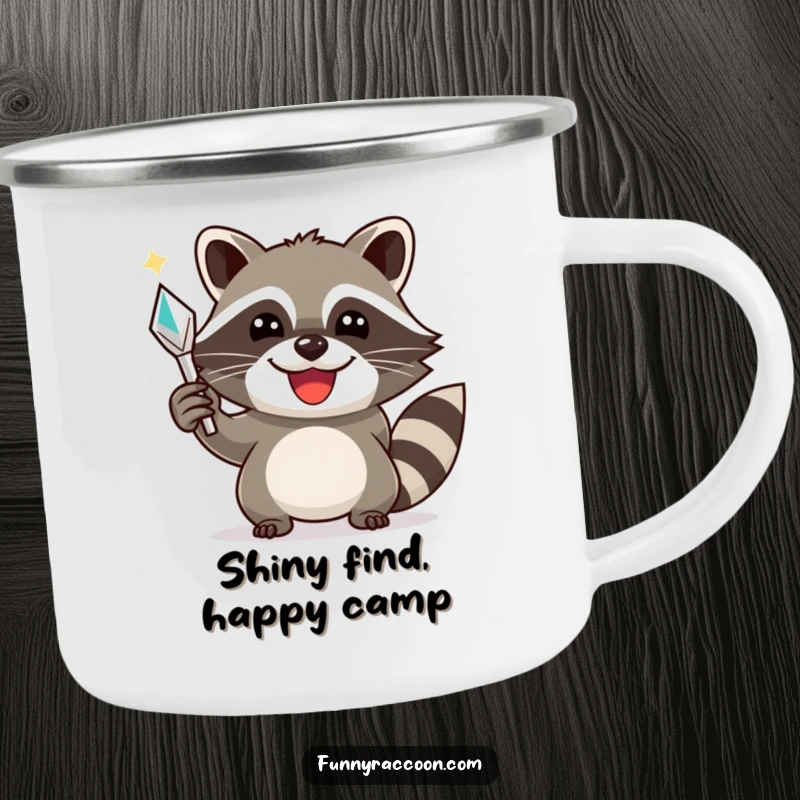 Funny raccoon camping mug, a smiling raccoon triumphantly holding a shiny object, designed for outdoor success.