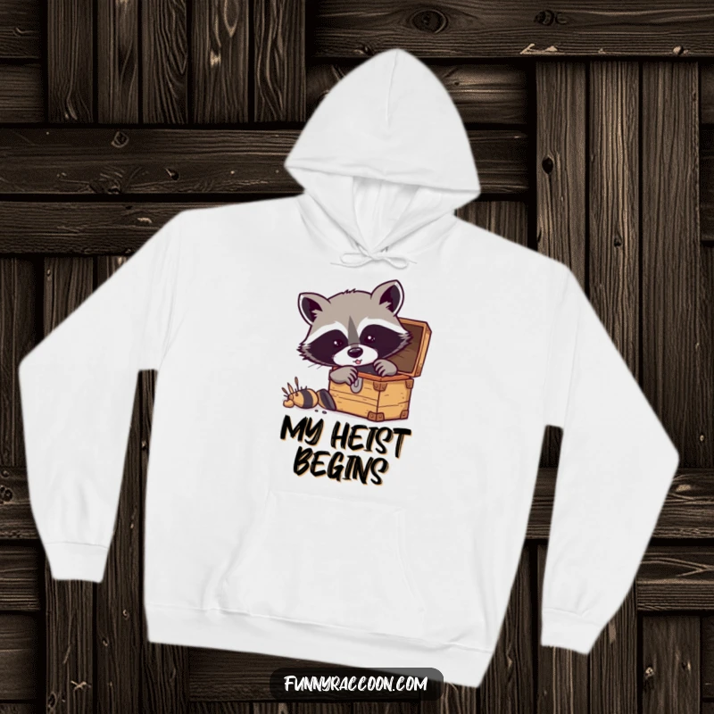 Funny raccoon hoodie featuring a masked raccoon enthusiastically digging into a treasure chest.