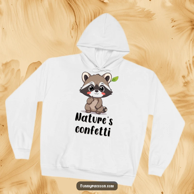Funny Raccoon Hoodie: A raccoon with amazed eyes points at a floating leaf, symbolizing curiosity and comfort.