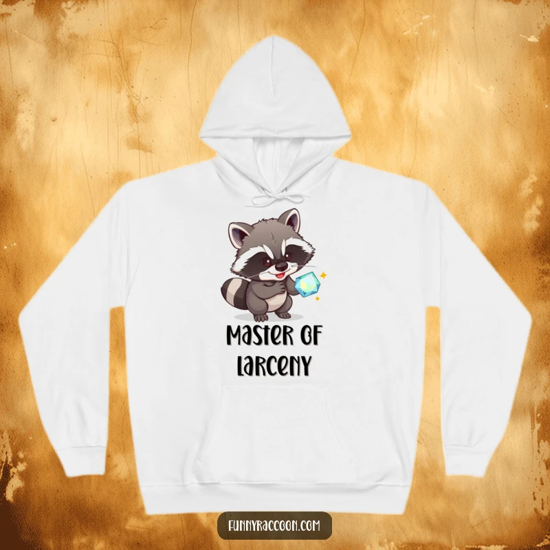 Funny Raccoon Hoodie: A crafty raccoon smirks while plotting to steal a sparkly gem, a humorous and cozy apparel item.
