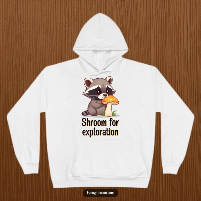 A cozy hoodie featuring a funny raccoon with a curious expression intently examining a vibrant, oversized mushroom.