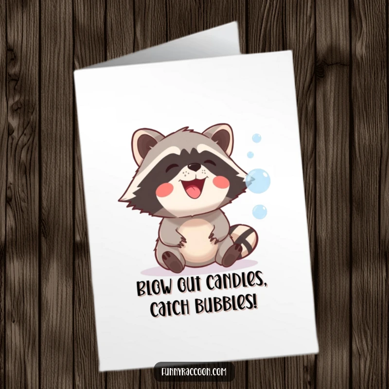 Funny Free Printable Birthday Card: Raccoon with a wide grin chasing and trying to catch floating bubbles.