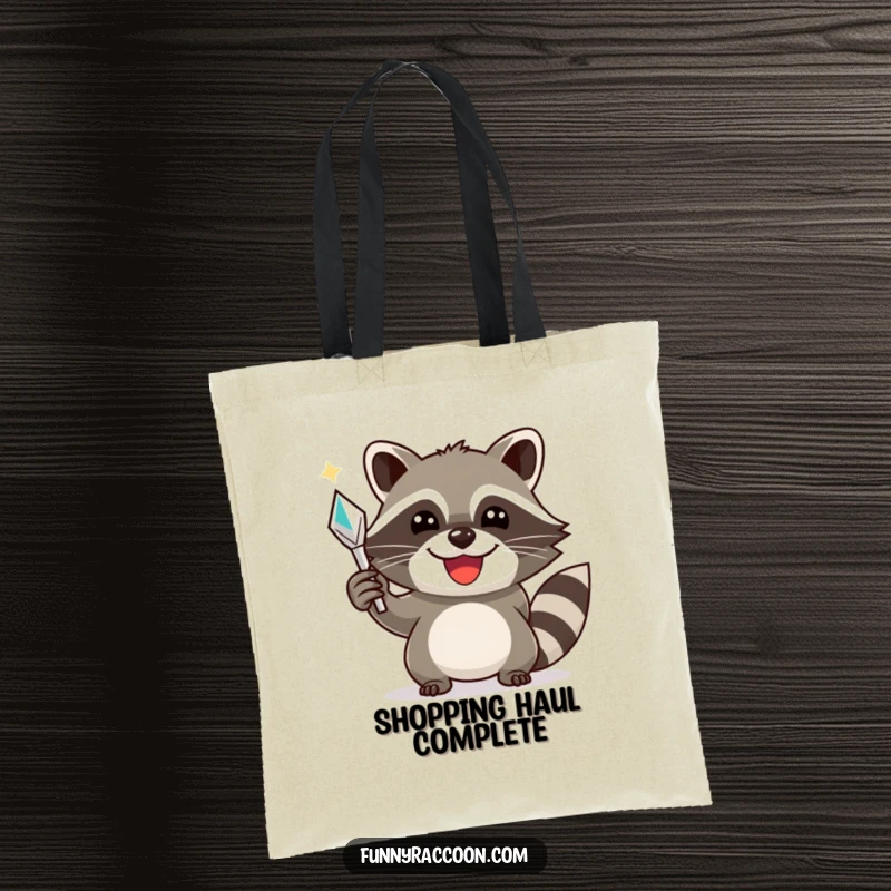 Funny raccoon tote bag, a smiling raccoon triumphantly holding a shiny object, ideal for carrying treasures and joy.